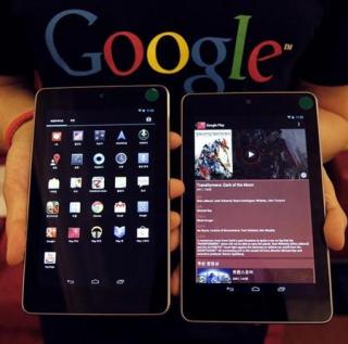 A Google employee poses with Nexus 7 tablets at a promotional event in Seoul